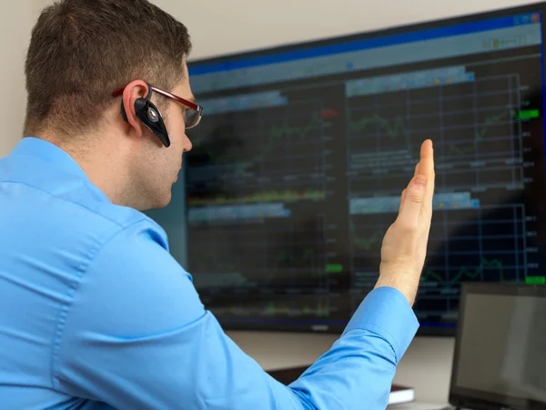 Angry stock trader in front of computer.