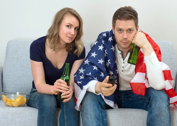 American fans watching sports match on tv.