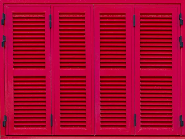 Window with red shutters. Close-up view.