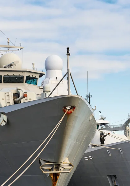 Close-up view of naval ships with guns.