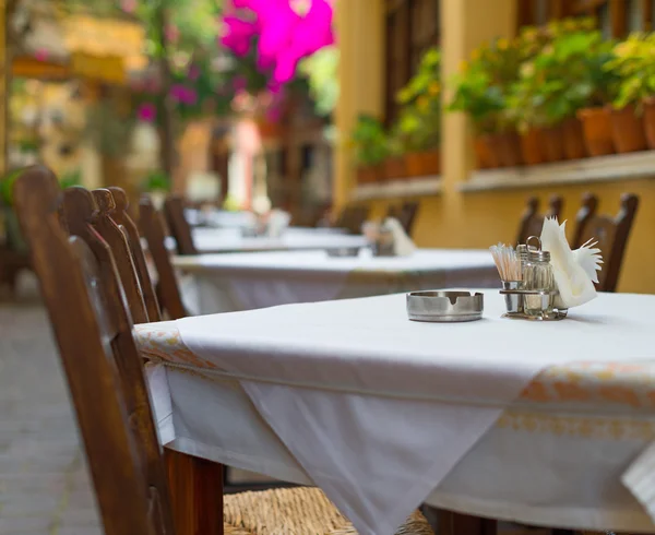 Mediterranean restaurant terrace exterior with chairs.