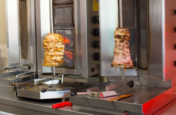 Pita gyros preparation on the kitchen in street cafe.