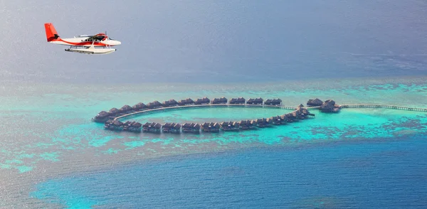 Sea plane flying above Maldives islands