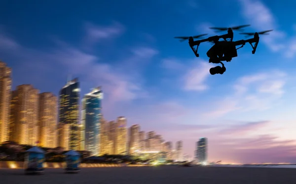 Drone silhouette flying above Dubaicity panorama