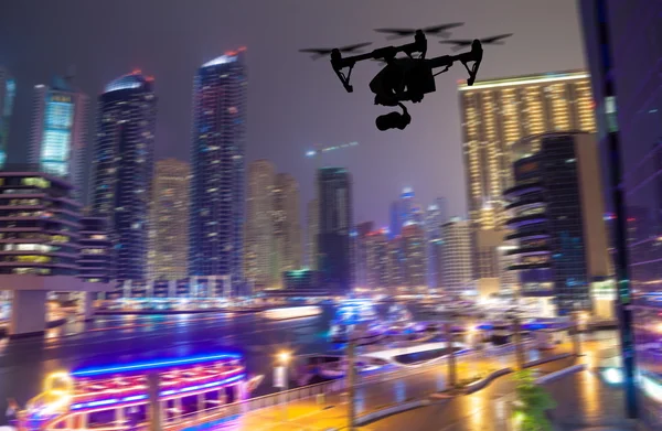 Drone silhouette flying above Dubaicity panorama