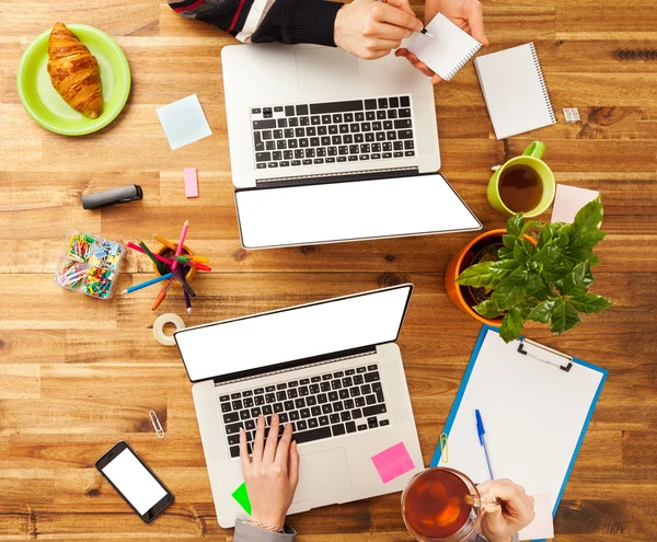 Man and woman working on laptops