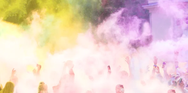 Close-up of marathon runners with colored powder