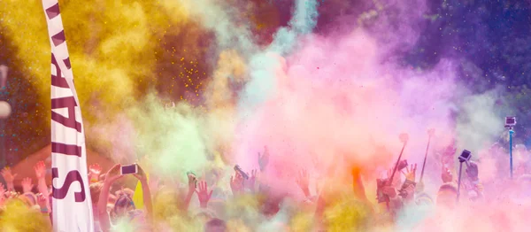 Close-up of marathon runners with colored powder