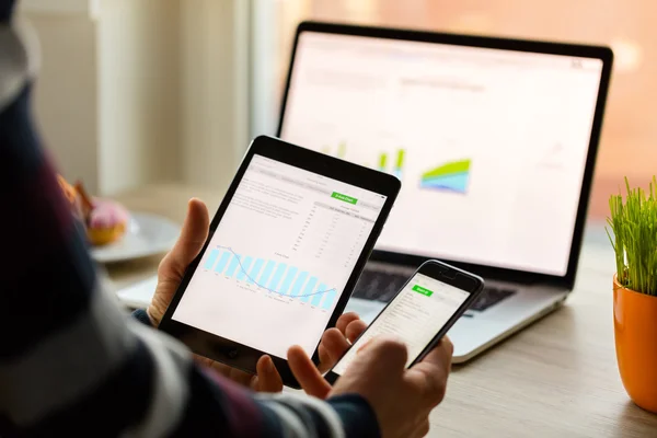 A man hand holding screen Apple app showing on IPad mini in office. Apple is the most valuable technology company in the World. PRAGUE, CZECH REPUBLIC - NOVEMBER 17,2015