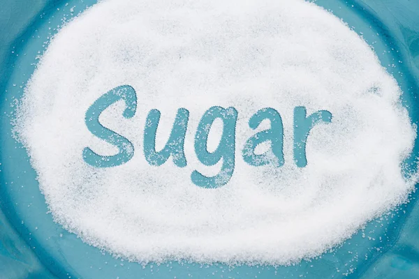 Close-up of Teal Plate with a lot of sugar with text Sugar