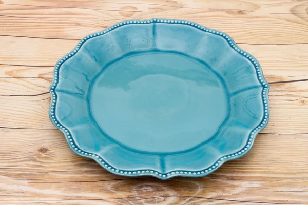 Empty Teal Plate on a weathered wood background