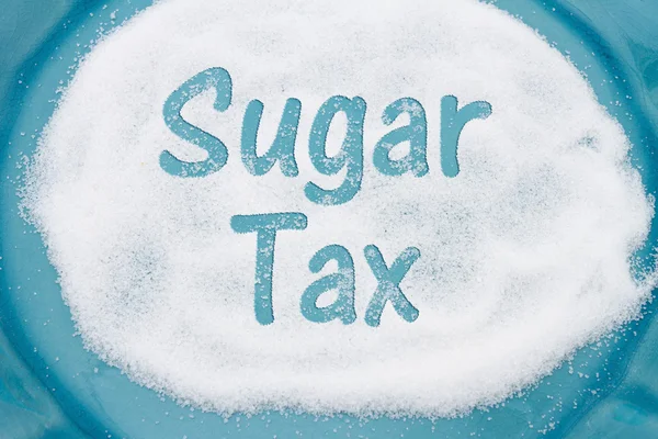 Close-up of Teal Plate with a lot of sugar with text Sales Tax