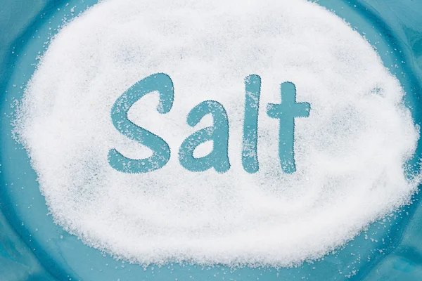 Close-up of Teal Plate with a lot of salt with text Salt