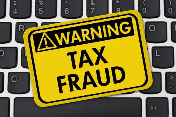 Online Tax Fraud, computer keyboard and yellow warning sign