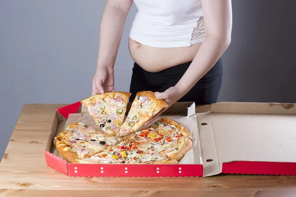 Fat woman with a piece of pizza in hand, obesity concept