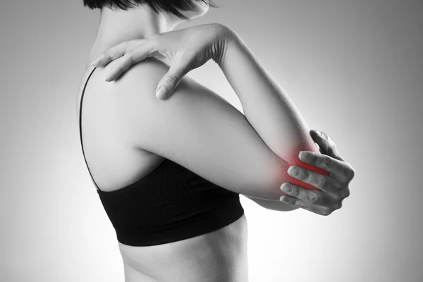 Woman with pain in elbow. Pain in the human body