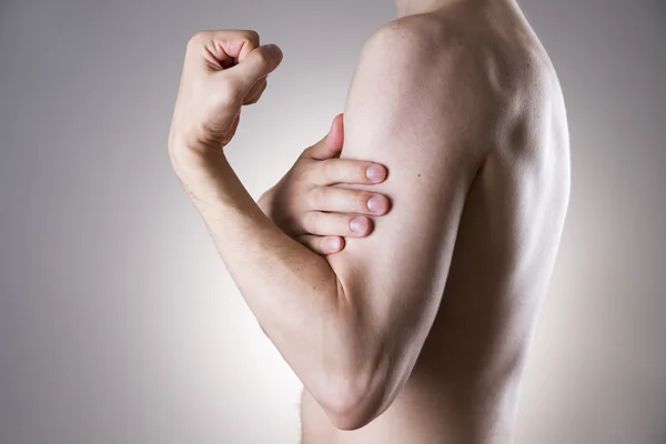 Man with pain in arm. Pain in the human body