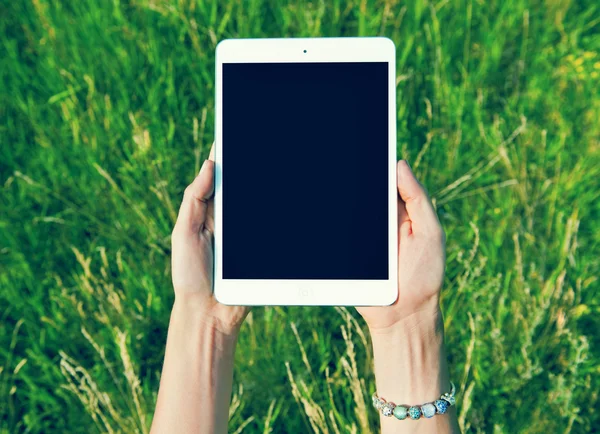 Female teen hands using tablet pc with black screen