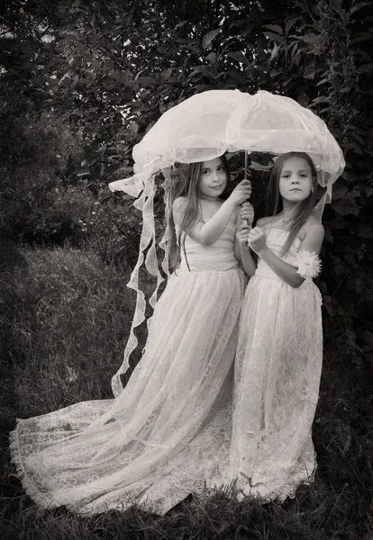 Vintage photo of two girls with umbrella