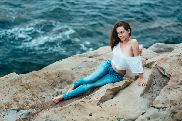Woman in jeans near the sea