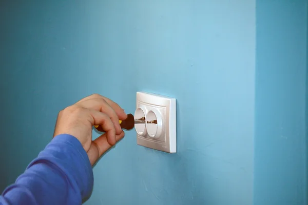Electrician fixing the socket