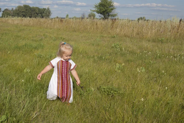 Toddler girl walking in a national style Ukrainian dress
