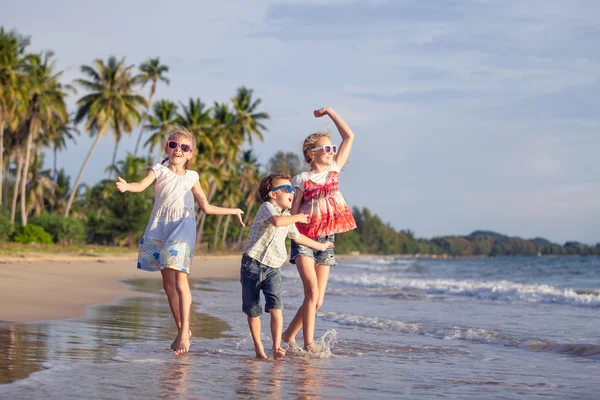 Happy family playing on the beach at the day time.