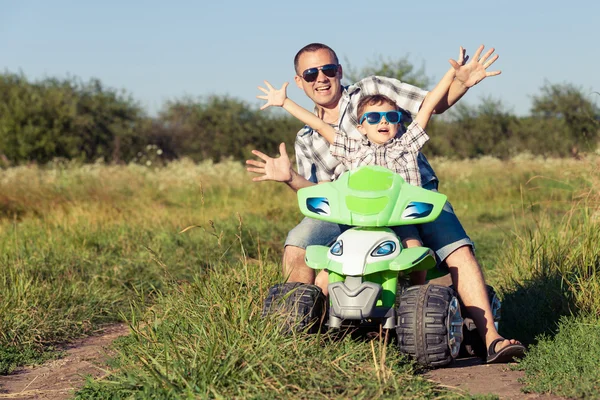 Father and son playing on the road at the day time.