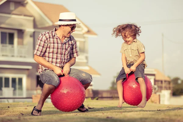 Father and son playing on the grass