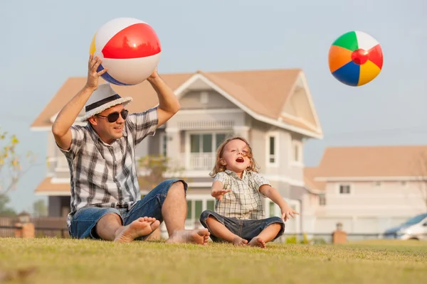 Father and son playing on the grass