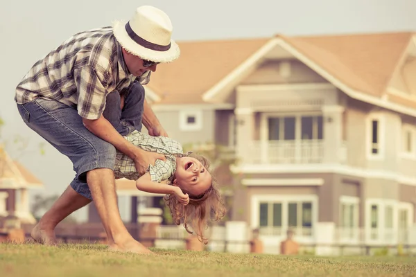 Father and son playing on the grass