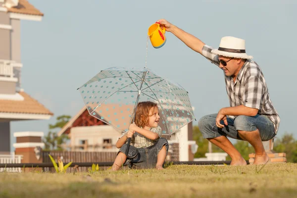 Father and son playing on the grass