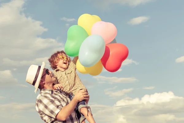 Dad and son playing near a house