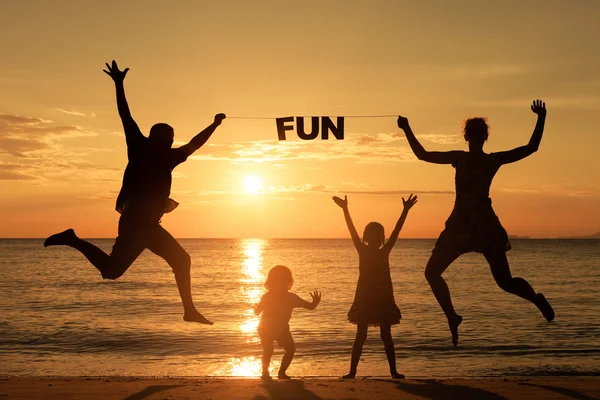 Happy family standing on the beach