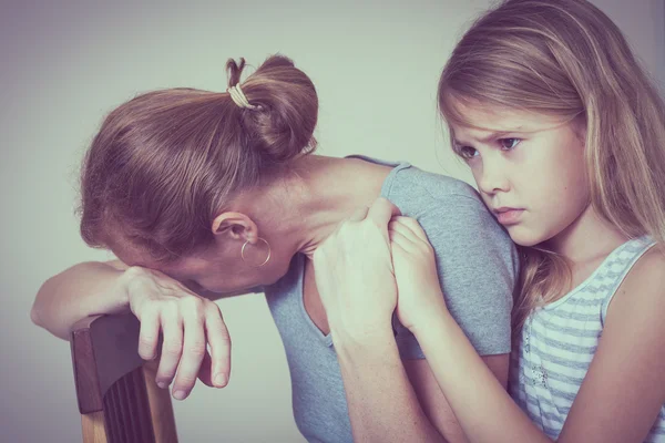 Sad daughter hugging his mother