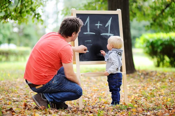 Father and his son practicing mathematics