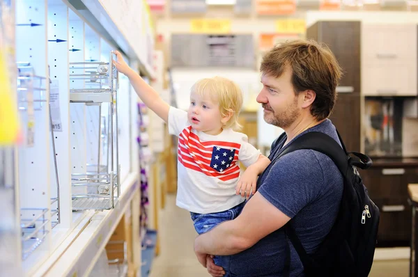 Family choosing the right furniture for their apartment in a modern home furnishings store