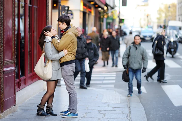 Young dating couple embrace on a street of Paris, France