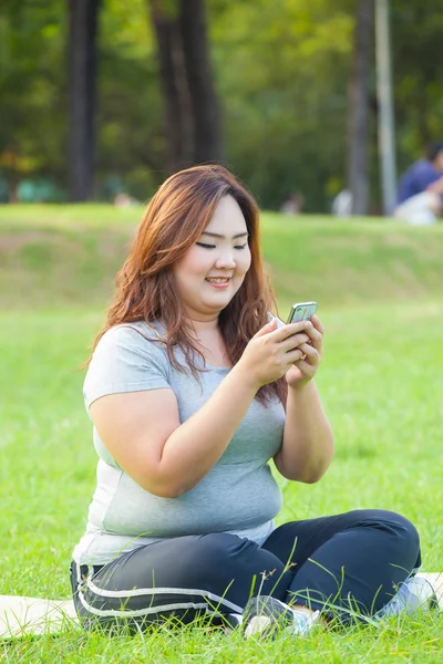 Happy fatty woman using mobile phone