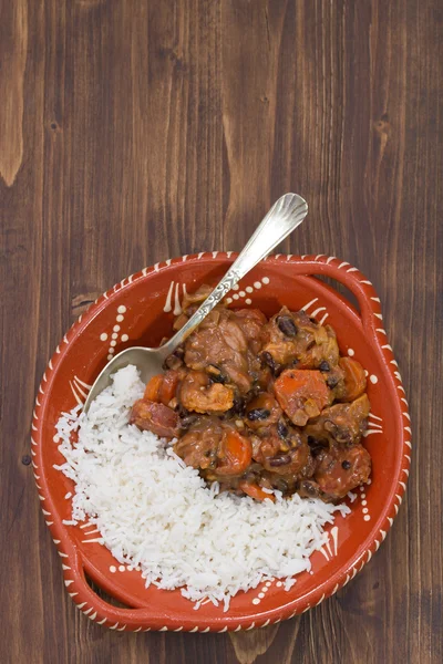 Typical portuguese dish feijoada with rice in ceramic bowl
