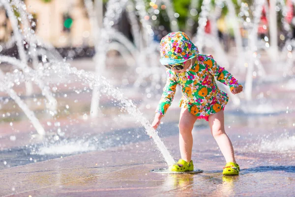 Toddler playing with fountains