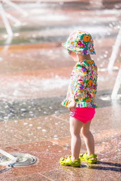 Toddler playing with fountains