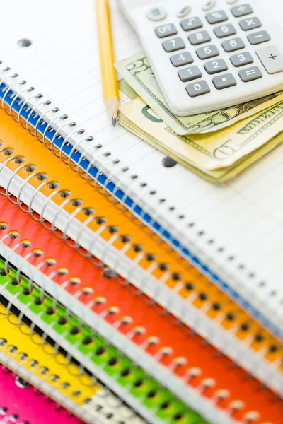 Calculator and cash on notebook, School supplies