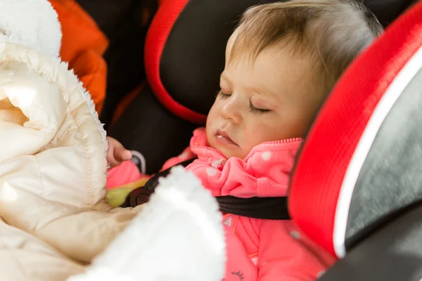 Baby girl sleeping in her car seat