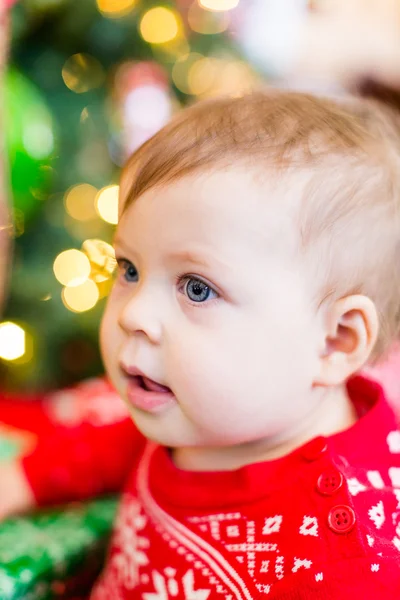 Baby girl next to Christmas tree