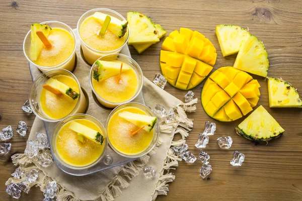 Popsicles made with mango, pineapple and coconut milk