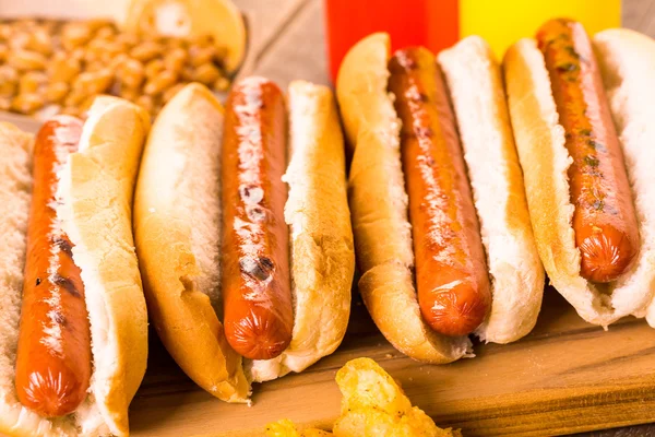 Grilled hot dogs on a white hot dog buns