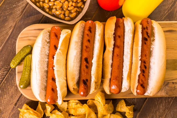 Grilled hot dogs on a white hot dog buns