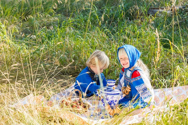Little kids in Russian costumes