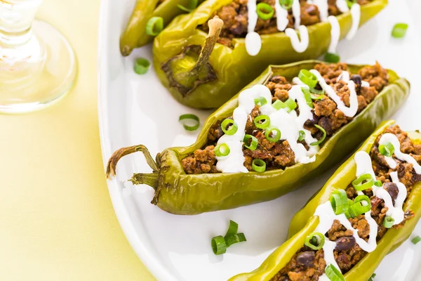 Chipotle beef and bean stuffed chile peppers